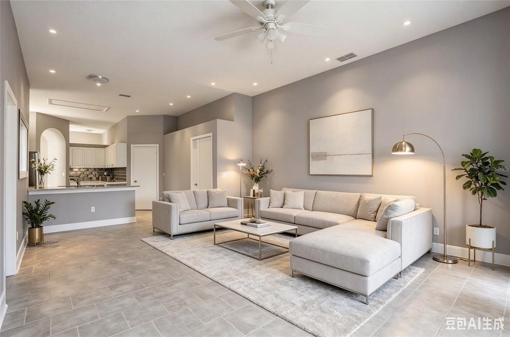 An open-concept living area features gray walls, tile flooring, and a ceiling fan — 12834 WOODBURY GLEN DRIVE, ORLANDO, FL