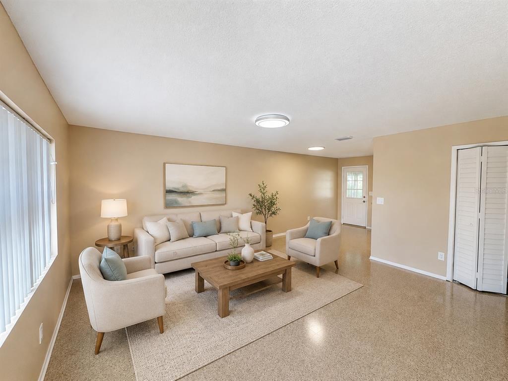A living room features a beige sofa, two armchairs, a coffee table, and light-colored flooring — 5222 BOGDONOFF DRIVE, SEFFNER, FL