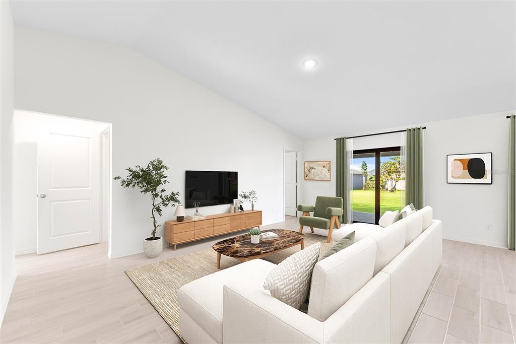 This digital rendering shows a living room with a white sofa, television, and sliding doors — 3510 E ELIAS CIRCLE, NORTH PORT, FL