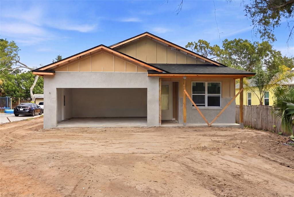 A single-story house under construction features a large garage, an unfinished exterior, and a porch — 2139 20TH AVENUE SW, LARGO, FL