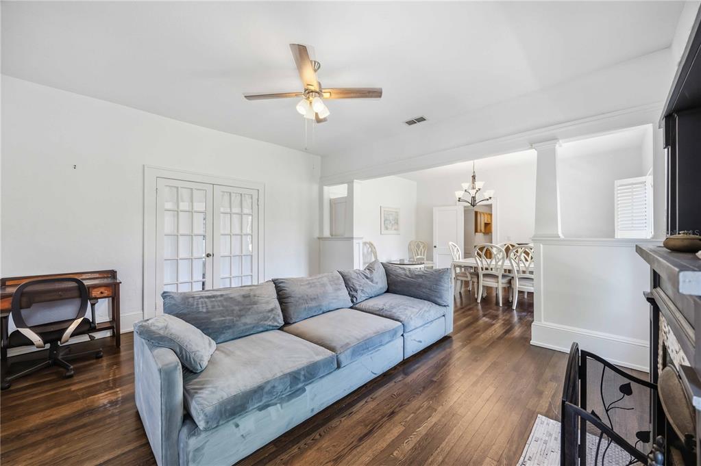 A living room features a grey sofa, dark hardwood floors, and a ceiling fan — 815 SOLONA LOOP, PUNTA GORDA, FL