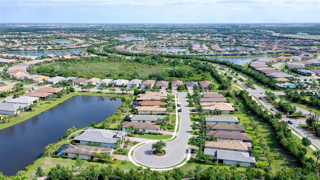 An aerial view shows a residential neighborhood with a cul-de-sac and a highlighted house — 7636 KIRKLAND COVE, LAKEWOOD RANCH, FL