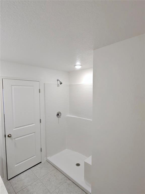 A kitchen with gray cabinets, stainless steel appliances, a kitchen island, and light-colored tile flooring — 527 HANSARE STREET SW, PALM BAY, FL
