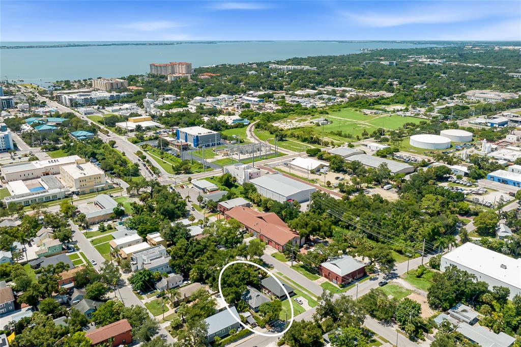 An aerial view shows a residential house circled in a neighborhood near a large body of water — 919 GOODRICH AVENUE, SARASOTA, FL