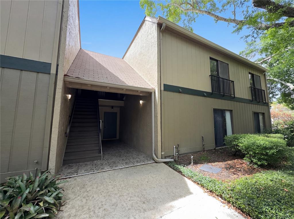 An exterior view of a two-story apartment building with an outdoor staircase and balcony — 240 MOREE LOOP UNIT 3, WINTER SPRINGS, FL