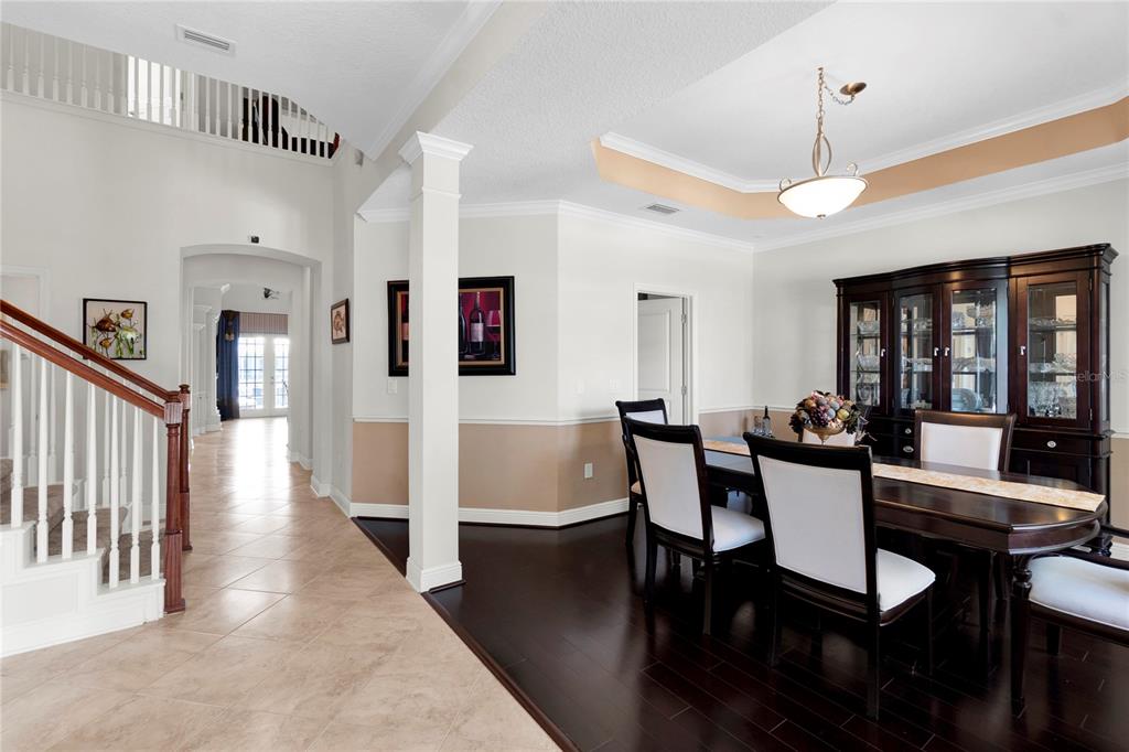 A two-story light blue house with a front porch, palm trees, and a paved walkway — 5727 SEA TROUT PLACE, APOLLO BEACH, FL