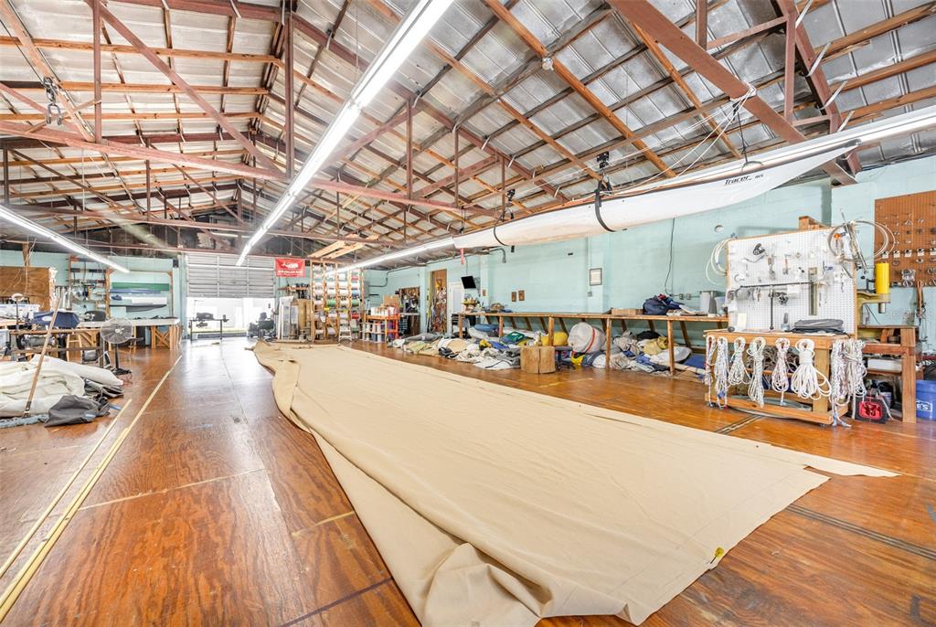 A large, open workshop with a high vaulted ceiling, wooden floors, and a long sail — 229 FORREST AVENUE, COCOA, FL