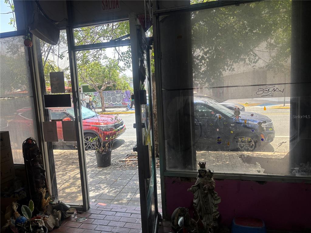A view from inside a storefront looking out through a glass door at a street — 1001 PONCE DE LEON AVENUE UNIT 2, SAN JUAN, PR