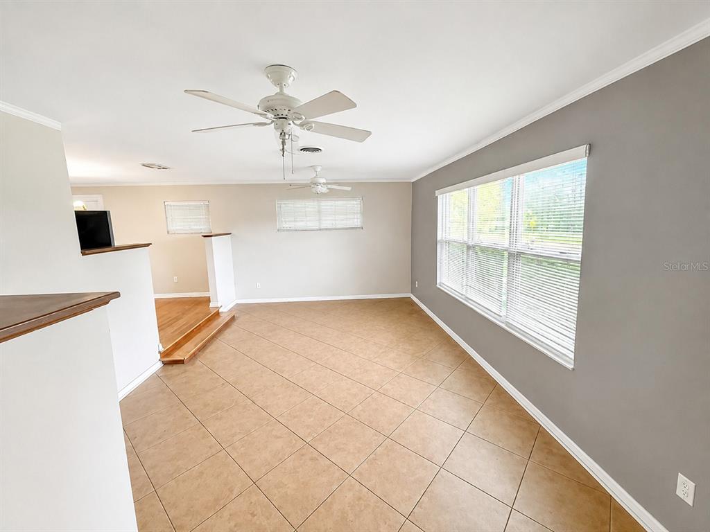 A bathroom features a white vanity, a tub-shower combo, and navy blue walls with tile — 409 MONTGOMERY AVENUE, LAKELAND, FL
