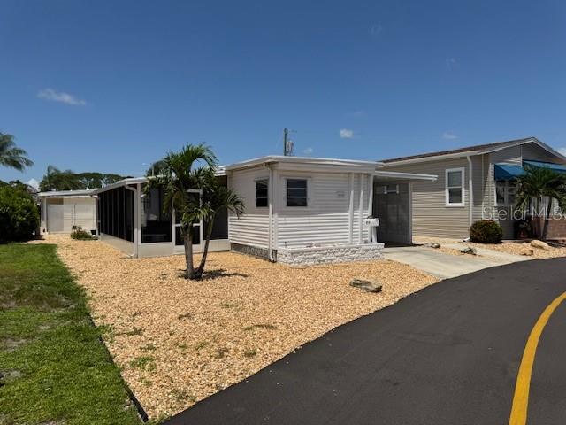 An aerial view shows a residential neighborhood with a mobile home park and commercial buildings — 251 SOUTHWINDS DRIVE, SARASOTA, FL