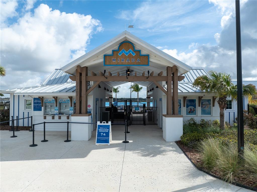 The exterior of the Mirada lagoon entrance features a covered walkway with a gated entry — 31875 MAGNA GULF LOOP, SAN ANTONIO, FL