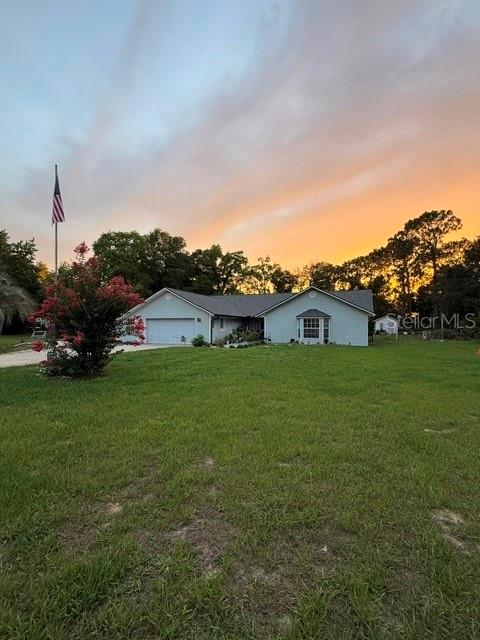 A concrete walkway leads along the side of a house toward a grassy backyard — 40145 W 7TH AVENUE, UMATILLA, FL