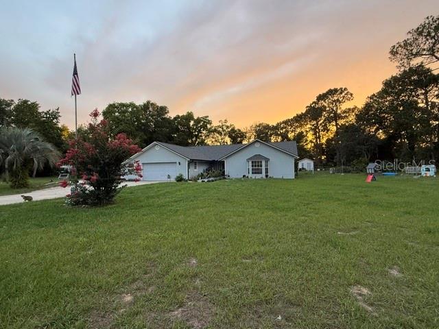 A covered porch features light blue siding, a wooden bench, and a dark blue double door — 40145 W 7TH AVENUE, UMATILLA, FL