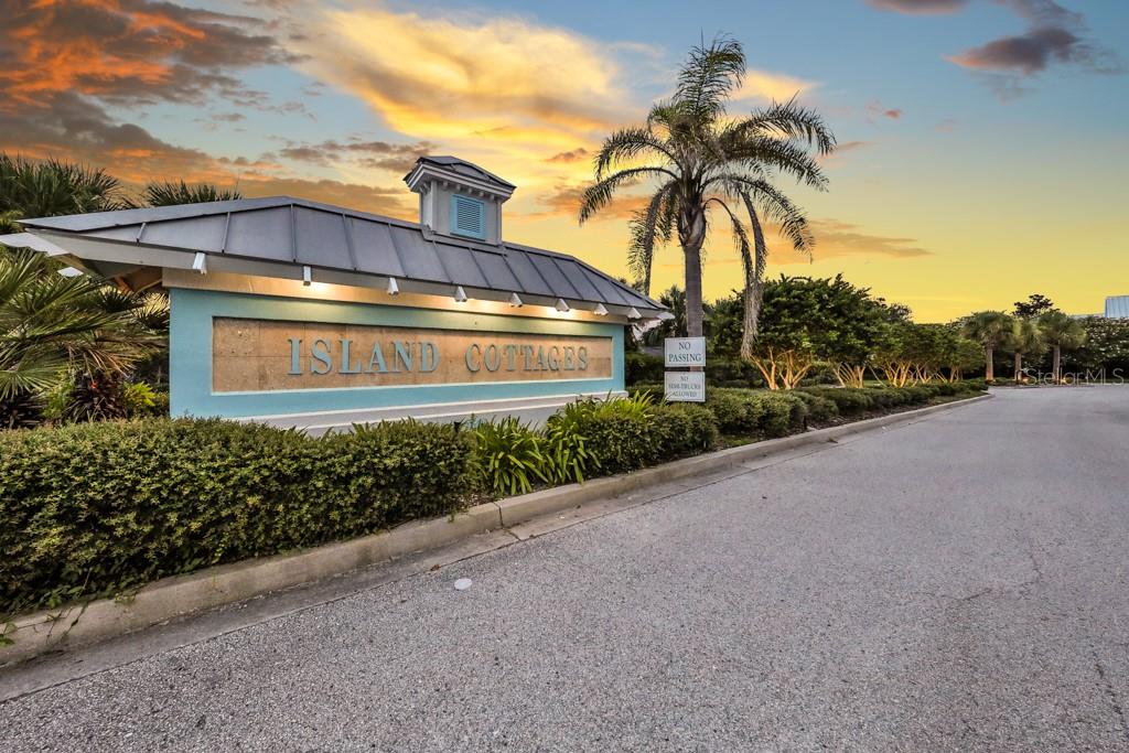 An exterior view of a community entrance sign for Island Cottages with a palm tree — 136 ISLAND COTTAGE WAY WAY, ST AUGUSTINE, FL