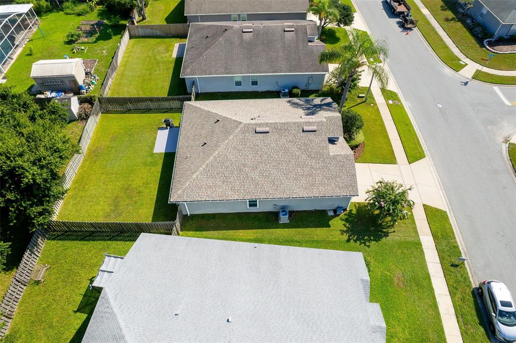 An aerial view shows a suburban house with a gray roof and a fenced backyard — 138 BRIGHTVIEW DRIVE, LAKE MARY, FL