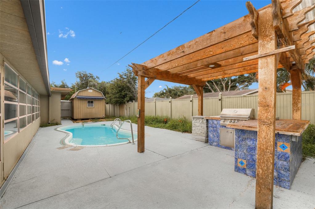 A single-story house with a brick facade, a two-car garage, and a paved driveway — 6450 31ST TERRACE N, ST PETERSBURG, FL