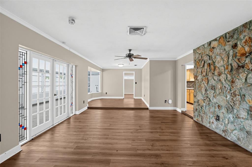 A backyard features a swimming pool, a wooden pergola, and a house with screened windows — 6450 31ST TERRACE N, ST PETERSBURG, FL