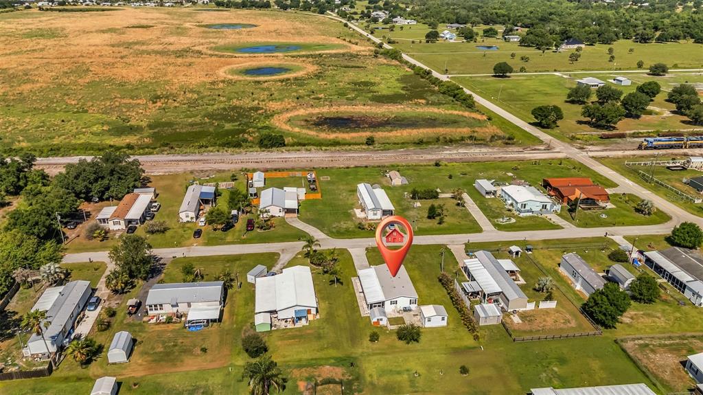 An aerial view shows a residential neighborhood with a red location pin over a house — 11710 SW ORANGE AVENUE, ARCADIA, FL