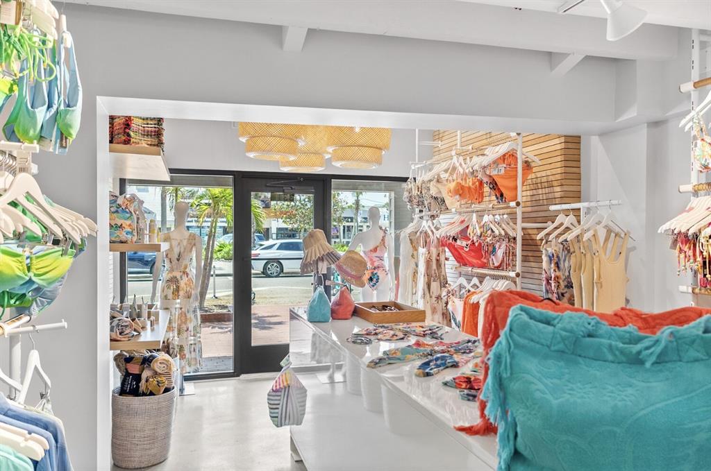 A retail clothing store interior features racks of swimwear, display tables, and a glass entrance — 331 JOHN RINGLING BOULEVARD UNIT 101, SARASOTA, FL