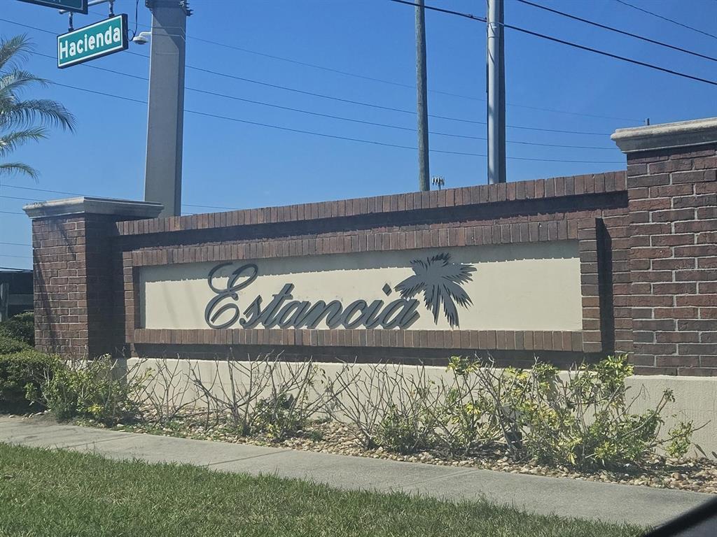 A brick monument sign displays the name Estancia next to a street sign for Hacienda — 1917 ESTANCIA CIRCLE, KISSIMMEE, FL