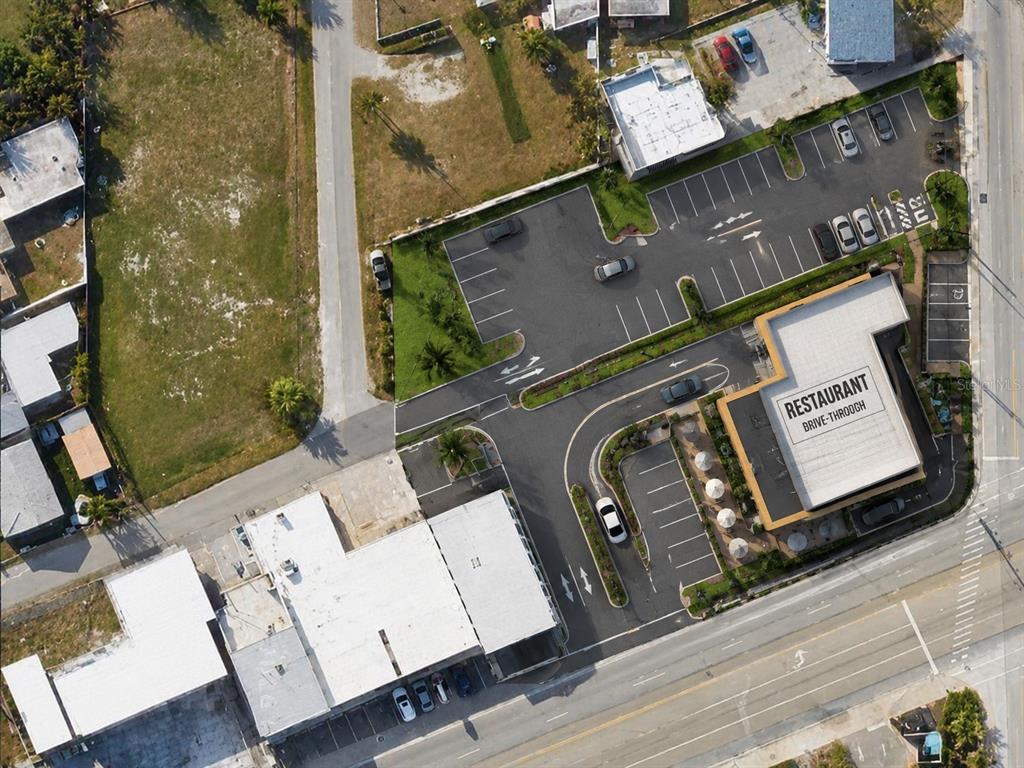 Aerial view of a commercial property featuring a restaurant with a drive-through and parking lot — 2000 S ATLANTIC AVENUE, DAYTONA BEACH, FL
