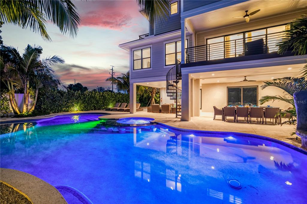A two-story house with a pool, hot tub, spiral staircase, and outdoor dining area — 171 MCKINLEY DRIVE, SARASOTA, FL