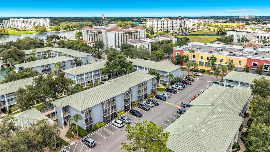 An aerial view shows multi-story apartment buildings with green roofs and a parking lot — 131 WATER FRONT WAY UNIT 220, ALTAMONTE SPRINGS, FL