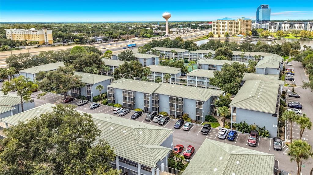 An aerial view shows a multi-story apartment complex with parking lots and surrounding trees — 131 WATER FRONT WAY UNIT 220, ALTAMONTE SPRINGS, FL