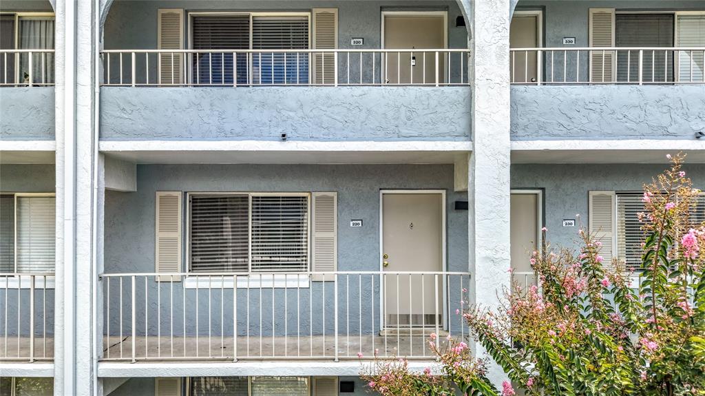 Exterior view of a multi-story apartment building with balconies, sliding windows, and numbered entry doors — 131 WATER FRONT WAY UNIT 220, ALTAMONTE SPRINGS, FL