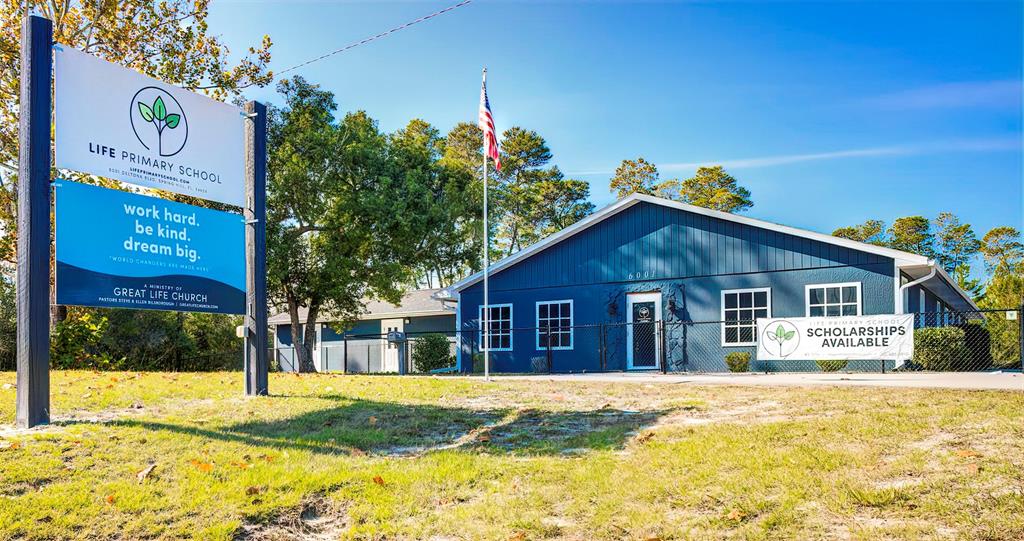 A blue building with a sign for Life Primary School stands on a grassy lot — 6001 DELTONA BOULEVARD, SPRING HILL, FL