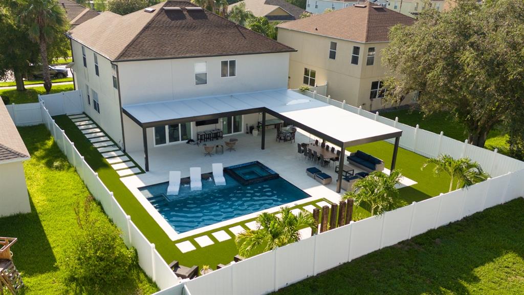 An aerial view of a backyard featuring a swimming pool, patio, and covered seating area — 526 FIRST CAPE CORAL DRIVE, WINTER GARDEN, FL