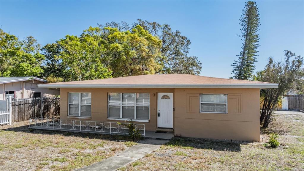 A single-story tan house with a low-pitched roof, white trim, and a front walkway — 5130 DR MARTIN LUTHER KING JR ST S, ST PETERSBURG, FL
