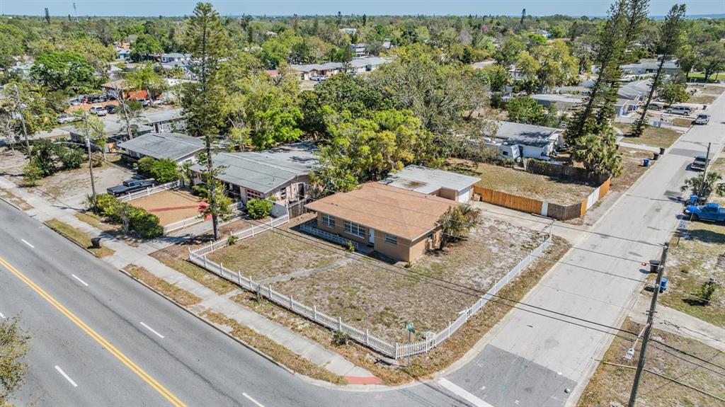 An aerial view shows a single-story house with a brown roof and a fenced yard — 5130 DR MARTIN LUTHER KING JR ST S, ST PETERSBURG, FL