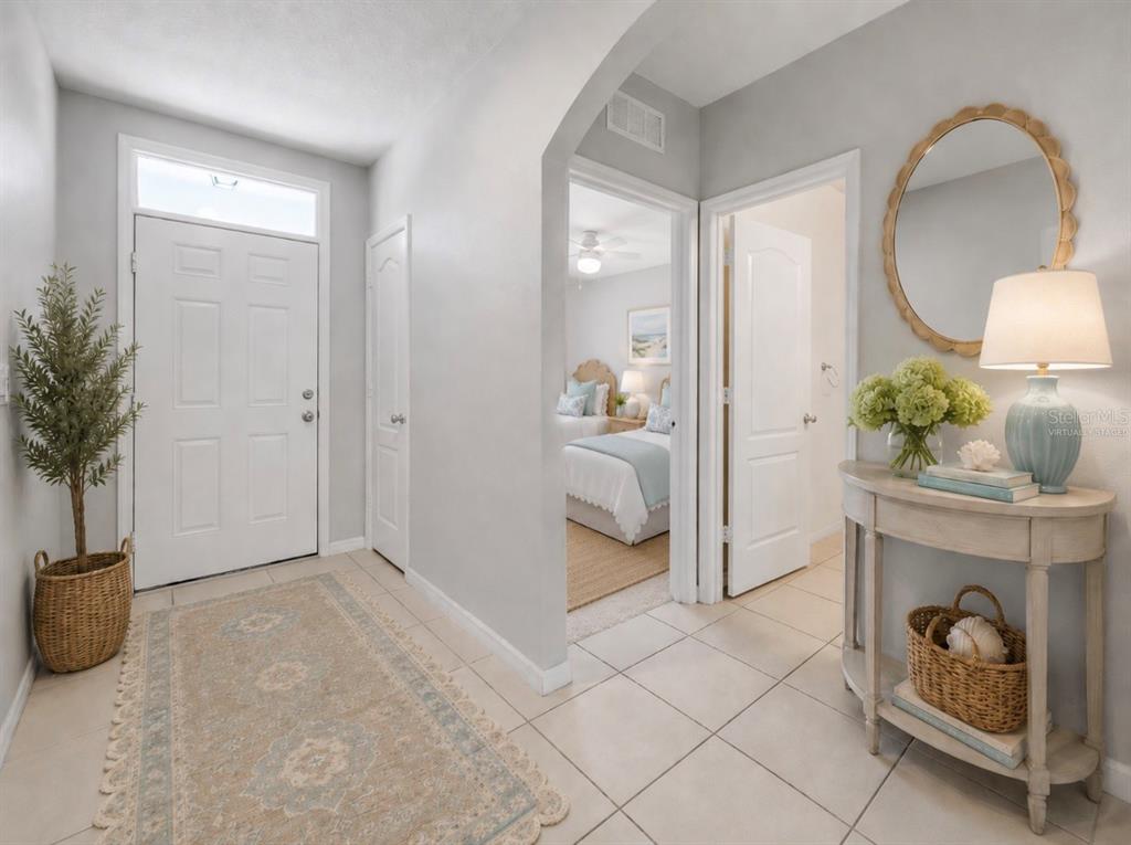 The exterior of a house features a light blue front door, garage, and window shutters — 4697 BAYFIELD HARBOR LANE, EDGEWATER, FL