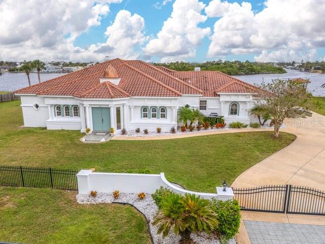 A white single-story house with a terracotta tile roof and a small copper cupola — 660 LAMBERT AVENUE, FLAGLER BEACH, FL
