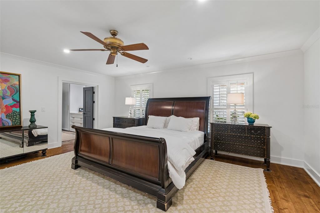 A bedroom features a dark wood sleigh bed, two matching nightstands, and a ceiling fan — 2807 W FOUNTAIN BOULEVARD, TAMPA, FL