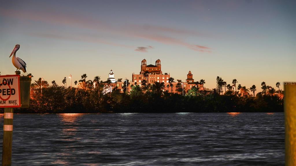 A pelican sits on a sign in front of a large hotel at sunset — 3606 BELLE VISTA DRIVE E, ST PETE BEACH, FL