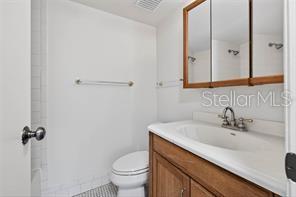 A screened-in porch with a ceiling fan, tiled floor, and a view of the outdoors — 219 PALMETTO COURT UNIT 219, OLDSMAR, FL