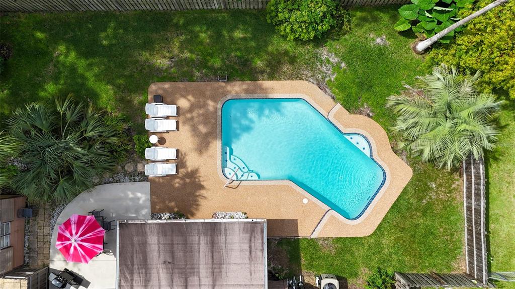 An aerial view shows a backyard with a swimming pool, patio, and lounge chairs — 608 TOUCHSTONE CIRCLE, PORT ORANGE, FL