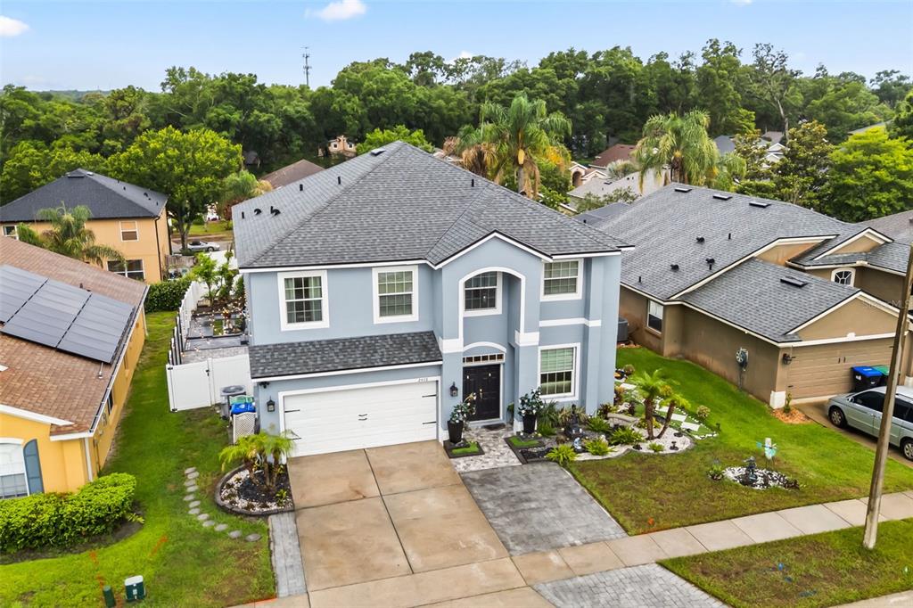 An aerial view of a two-story light blue house with a gray shingled roof — 2408 CIMMARON ASH WAY, APOPKA, FL