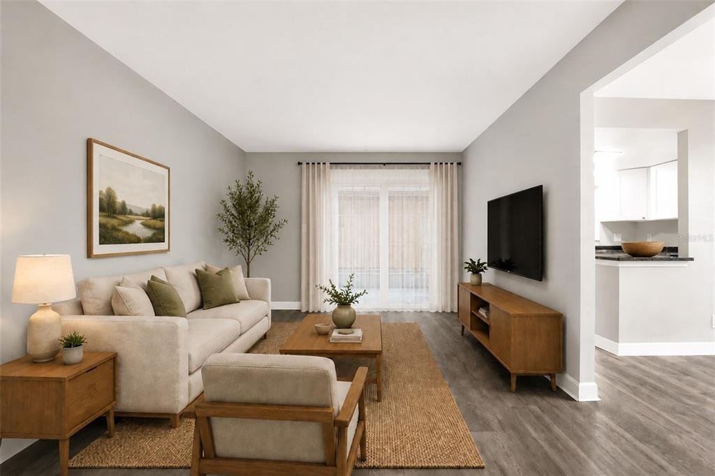 This is a digitally staged living room with a sofa, armchair, coffee table, and television — 8345 13TH STREET N UNIT B, ST PETERSBURG, FL
