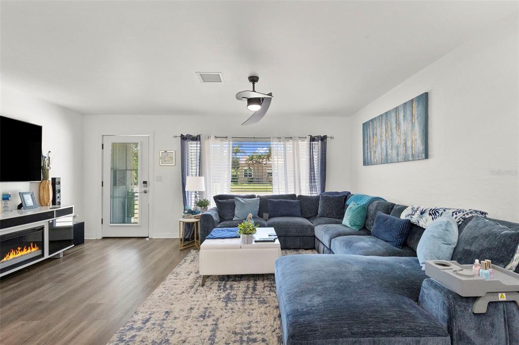 A single-story gray house with a concrete driveway and a white vinyl fence — 4832 5TH STREET S, ST PETERSBURG, FL