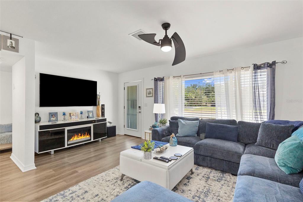 A single-story gray house with a concrete driveway, a front porch, and white fencing — 4832 5TH STREET S, ST PETERSBURG, FL