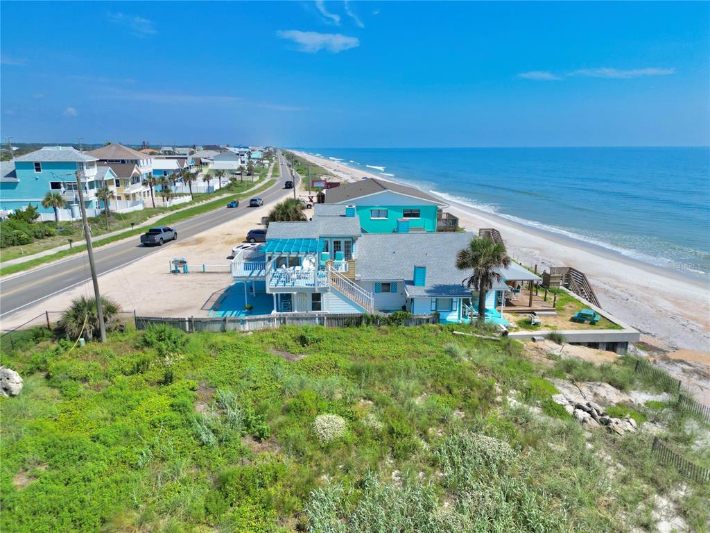 An aerial view of a beach house with a deck located between a road and ocean — 2815 S OCEAN SHORE BOULEVARD, FLAGLER BEACH, FL