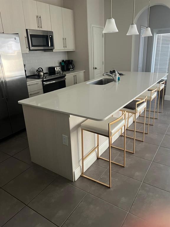 A laundry closet with a washer and dryer is located in a carpeted hallway — 209 MACAULAYS COVE, HAINES CITY, FL