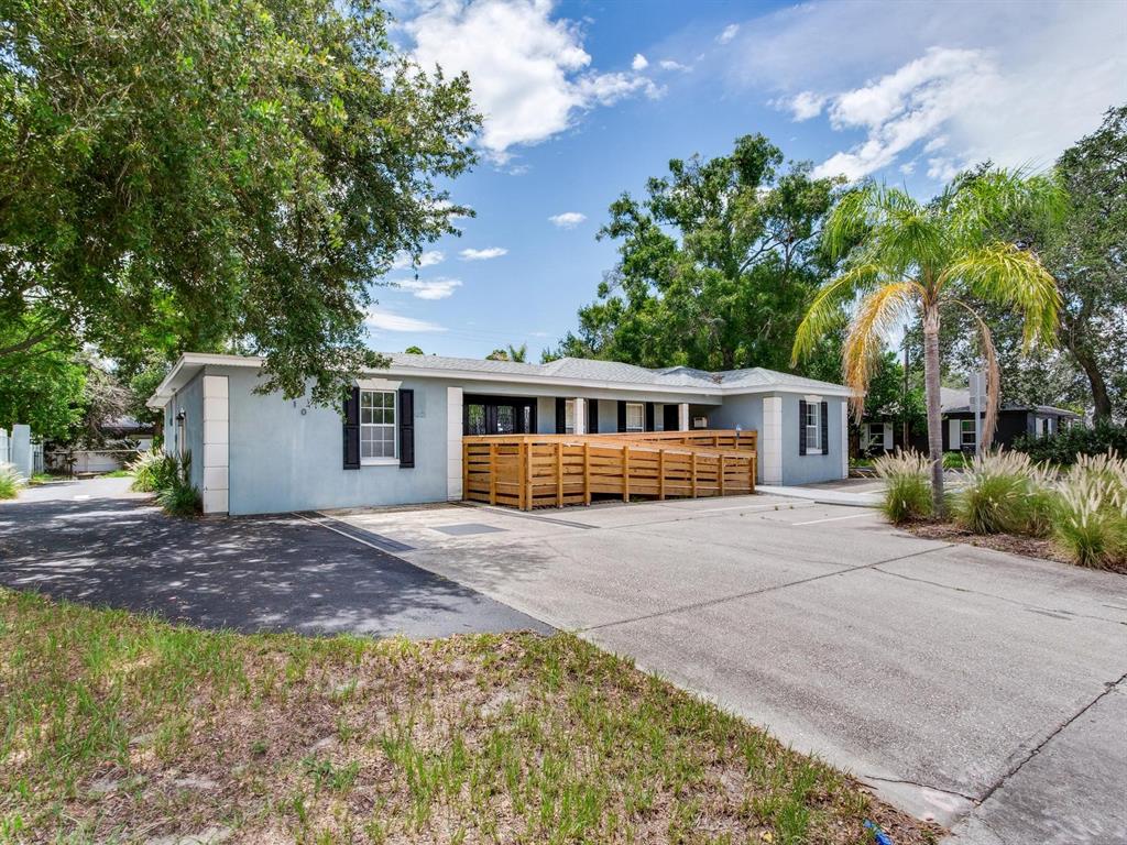 A light blue single-story building features a wooden wheelchair ramp leading to the front entrance — 3710 W AZEELE STREET, TAMPA, FL