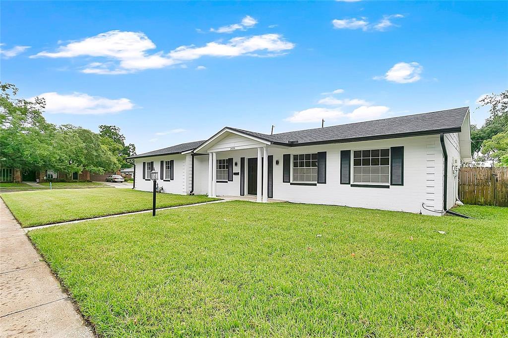 A single-story white brick house with black shutters and a covered front porch — 2494 CASTLEWOOD ROAD, MAITLAND, FL