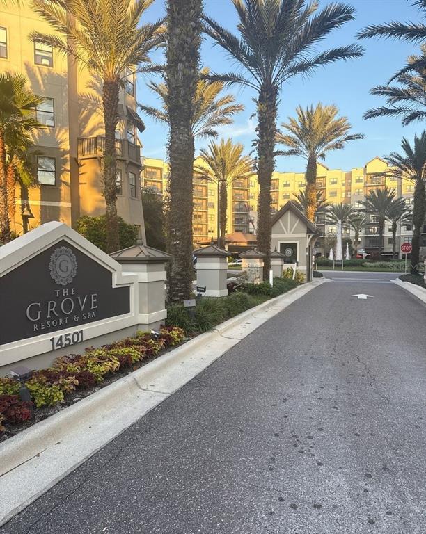 The entrance to The Grove Resort & Spa features a sign, palm trees, and buildings — 14501 GROVE RESORT AVENUE UNIT 2528, WINTER GARDEN, FL