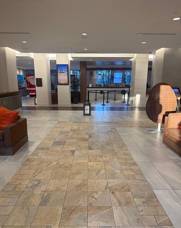 A hotel lobby features a tiled floor, seating areas, a reception desk, and a Santa statue — 14501 GROVE RESORT AVENUE UNIT 2528, WINTER GARDEN, FL