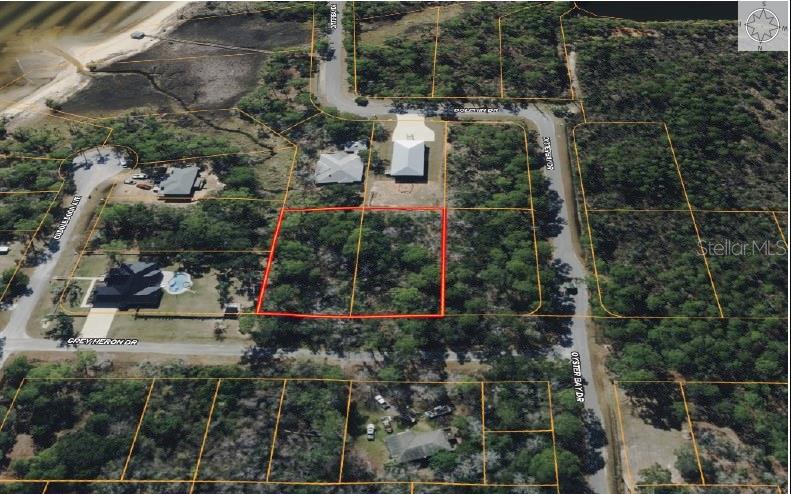 An aerial view shows two adjacent vacant lots outlined in red within a residential neighborhood — 6339 GREY HERON DRIVE, MILTON, FL